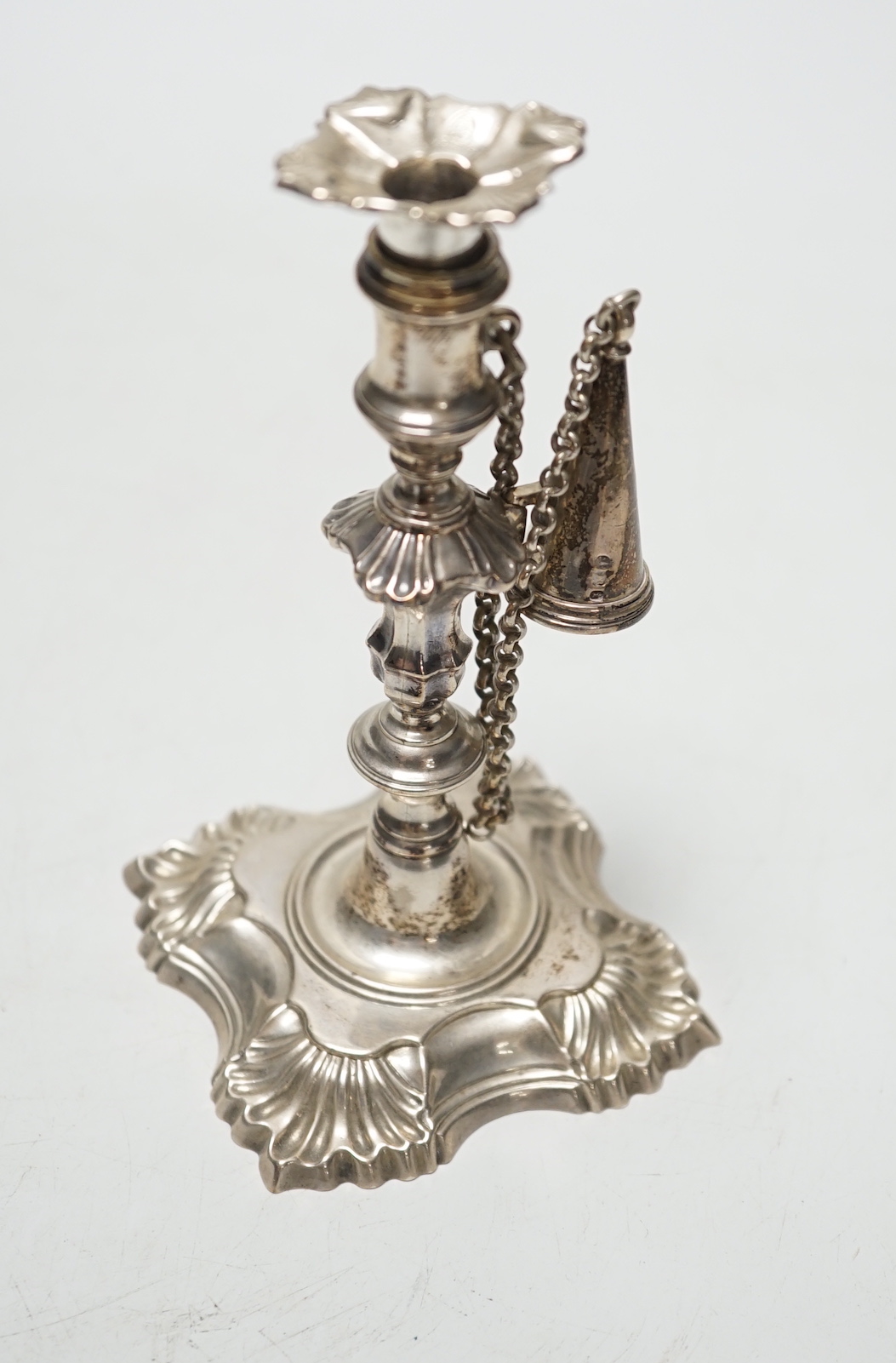 A George II cast silver taper stick, William Gould, London, 1751, with later George IV extinguisher and unmarked sconce, 13.3cm, 6.7oz.